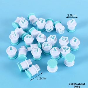 Detail of 26-piece spring-loaded alphabet and number cookie cutters for fondant baking
