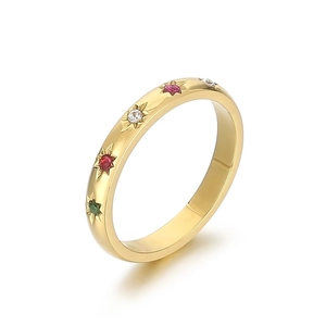 Elegant gold stainless steel ring featuring multi-color star-set crystals on white background
