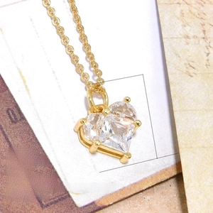 Detail of 18K gold-plated copper heart pendant with sparkling cubic zirconia stone