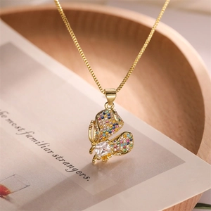 Macro view of gold butterfly pendant necklace with colorful sparkling zircon gemstones