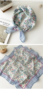 Macro detail of floral cotton linen neckerchief with blue hem and delicate flower prints