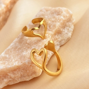 Minimalist 18K gold plated stainless steel heart rings on a decorative stone
