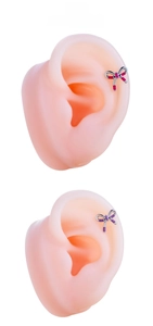 Detailed view of titanium steel bow earrings in magenta and purple enamel finish