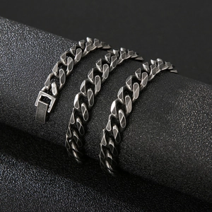 Detail of vintage hip-hop curb chain with jewelry clasp on a black cylindrical stand