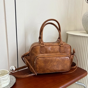 Retro brown PU leather backpack with large capacity and handle shown on wooden surface
