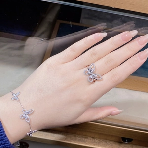 Detail view of silver butterfly bracelet and ring set with sparkling zircon stones