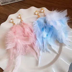 Elegant gold feather earrings with white pearls in soft pink and light blue styles