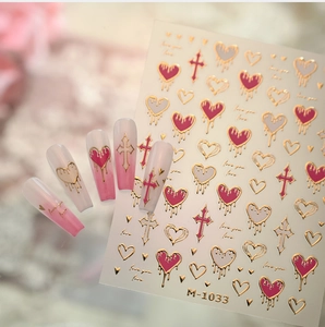 Detail of M-1033 nail art stickers with metallic gold hearts and cross patterns