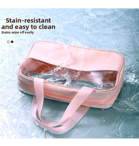 Waterproof pink canvas and transparent PVC makeup bag splashing in clear flowing water