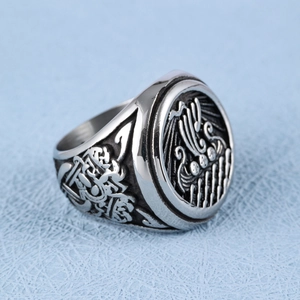 Close-up of vintage Viking ship relief and Celtic knot details on a men's signet ring