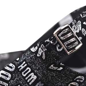Macro shot of baseball cap fabric with silver glitter lettering and metal buckle detail
