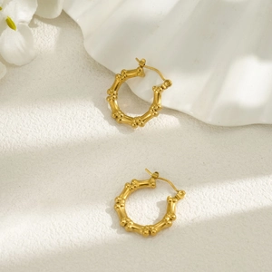 Detailed view of 18k gold plated stainless steel hoop earrings with unique bamboo texture