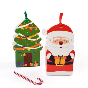 Christmas gift boxes in green Christmas tree and red Santa Claus designs with ribbons