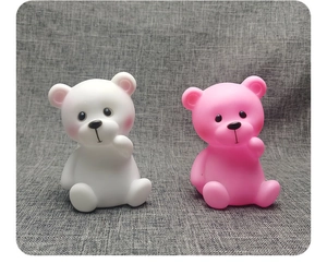 Detail shot of cute white and pink bear night lights with soft vinyl texture finish