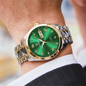 Detail of quartz business watch featuring a green dial and gold-tone steel bracelet
