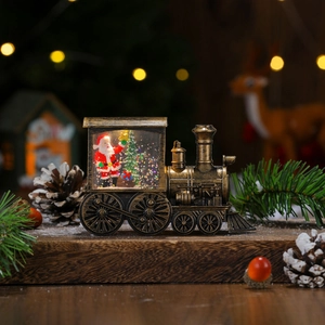 Detailed view of bronze Christmas train lantern with Santa and warm bokeh lights