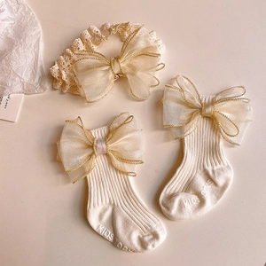 Infant beige headband and socks set with large organza bows and gold trim details