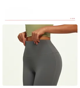 Detail view of high waisted wide waistband on dark grey yoga pants for tummy control