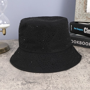 Close-up of black folding bucket hat with sparkling rhinestones on grey surface