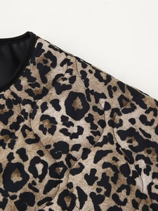 Detailed close-up showing the leopard print quilted fabric texture and stitching of the jacket