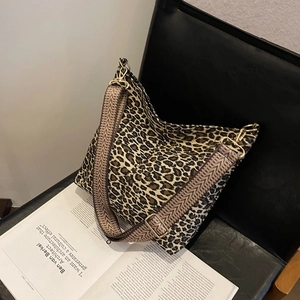 Fashionable leopard print canvas tote bag with wide herringbone strap on a chair
