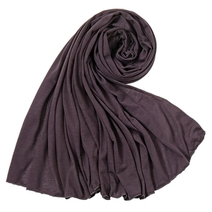 Close-up of deep charcoal jersey scarf showing soft texture and premium edge stitching
