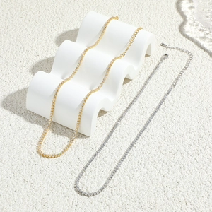 Detailed close-up of single row rhinestone necklaces in gold and silver finish