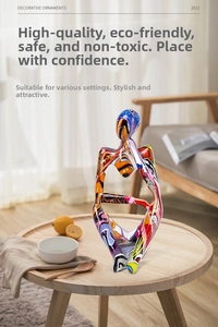 Artistic graffiti thinker statue detail with abstract colorful patterns on wood surface