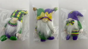 Three Mardi Gras gnomes in purple, green, and gold with plaid hats and bead necklaces