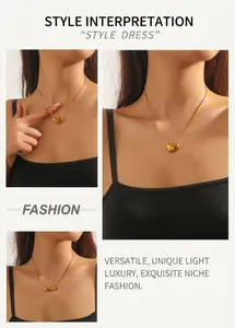 Close-up of golden lava heart pendant on a delicate snake chain worn at the collarbone