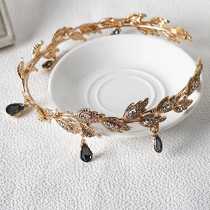 Detail of golden leaf crown with sparkling rhinestones and grey teardrop crystals