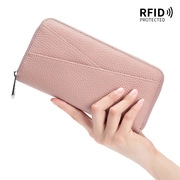 Detail of pink lychee leather long wallet with RFID protection and smooth metal zipper