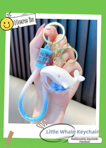 Detailed view of a dolphin keychain with blue liquid glitter and star sequins inside
