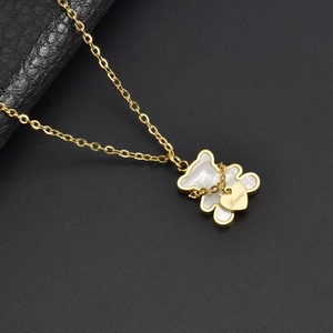 Golden bear necklace with white shell pendant and Love engraved heart charm on black leather