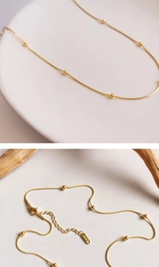 Detail of 18KGP stamp on gold snake chain with small beads and lobster clasp