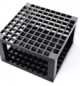 Close-up of a 96-grid black plastic holder for watercolor brushes and painting tools