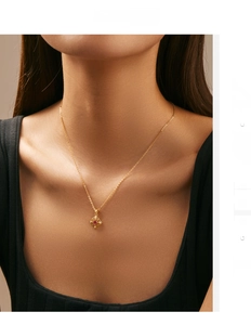 Detail of vintage hollow pendant necklace with red gemstone and diamonds on model