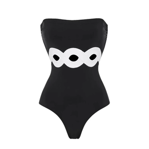 Detail of white interlaced cutout design on black one-piece swimsuit waistline