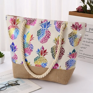 Detail of colorful laser pineapple print on canvas tote bag with jute base and rope handles
