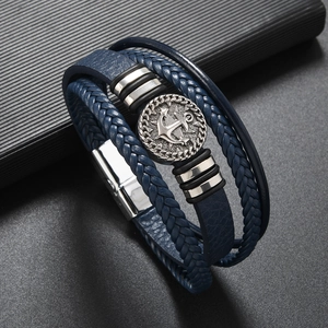 Detail of multi-layer men's leather anchor bracelet with magnetic silver metal clasp
