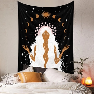 Bohemian sun and moon goddess tapestry shown hanging in a cozy bedroom setting