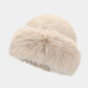 Detailed view of the soft faux fur texture on a warm winter bucket hat in beige