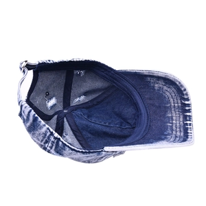 Detail showing distressed denim fabric and metal buckle adjustment on baseball cap