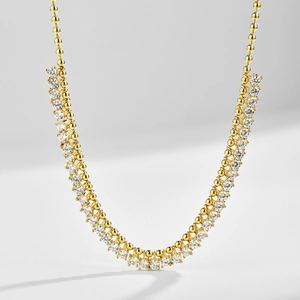 Macro shot of elegant double-row zircon crystals and gold beaded chain detail