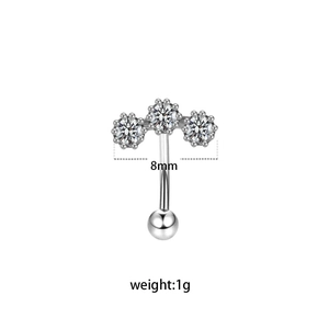 Detail view of 8mm curved barbell eyebrow ring with a sparkling zircon flower and bead