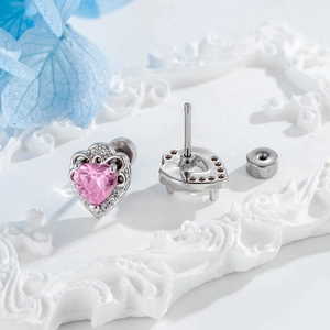 Delicate silver heart-shaped ear studs featuring pink zircon stones and screw back closure