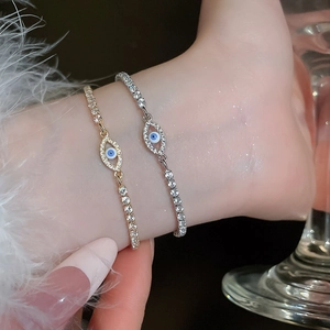 Close-up of sparkling evil eye bracelets with zircon pavé in gold and silver finish