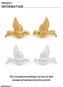 Detailed view of flying bird earrings in gold and silver with PVD vacuum plating finish