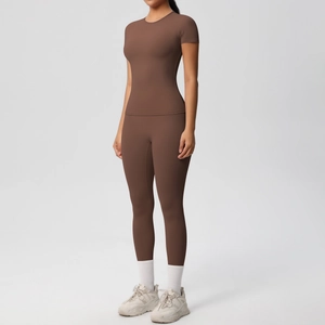 Detailed close-up of brown high-waisted yoga pants and matching stretch fitness t-shirt set