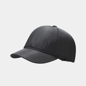 Macro detail of dark grey baseball cap featuring a unique hexagonal honeycomb texture
